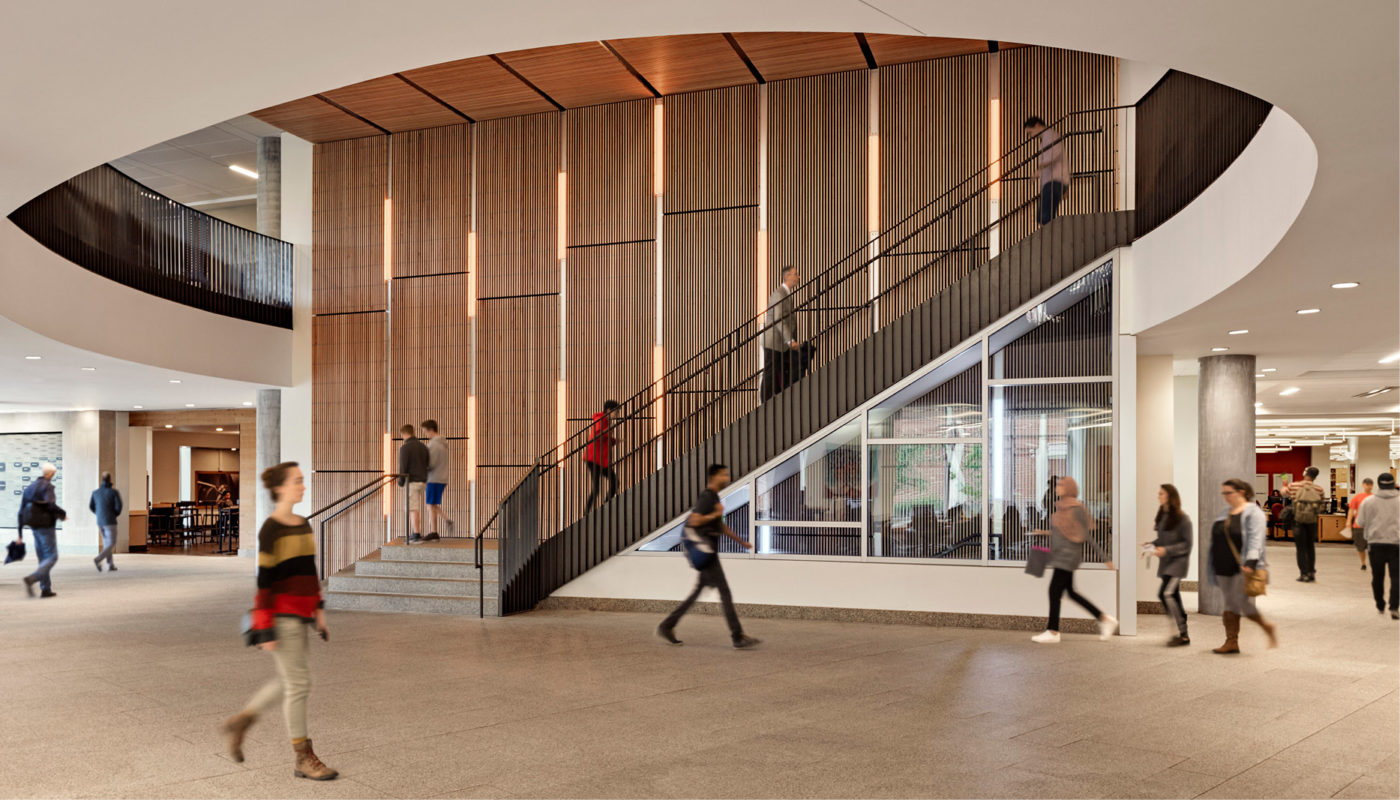 Students at Virginia Commonwealth University walking down a spiral staircase in James Branch Cabell Library.