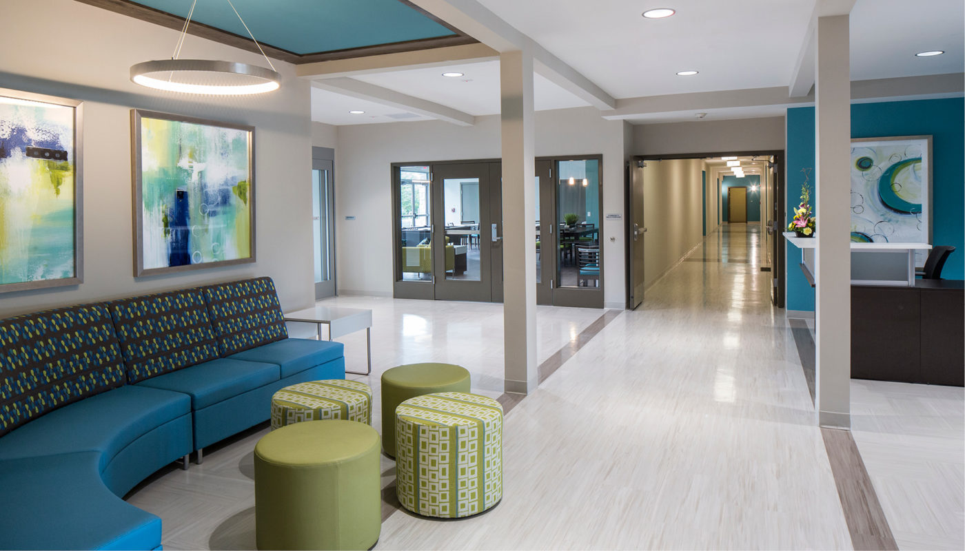 The lobby of Bon Secours hospital with blue couches and artwork.