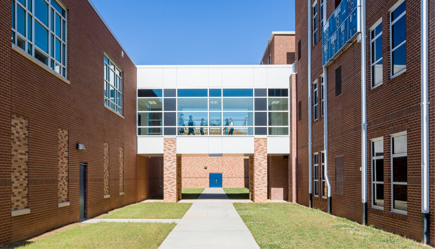 Mooresville High School, a brick building in the Mooresville Graded School District, with a blue door.