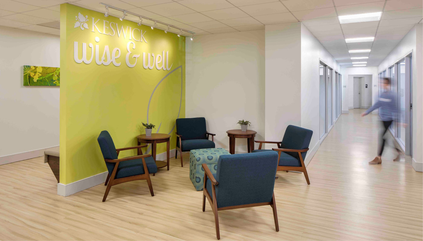 The Wise and Well Center, promoting Healthy Living, features a lobby with comfortable chairs and a refreshing green wall.