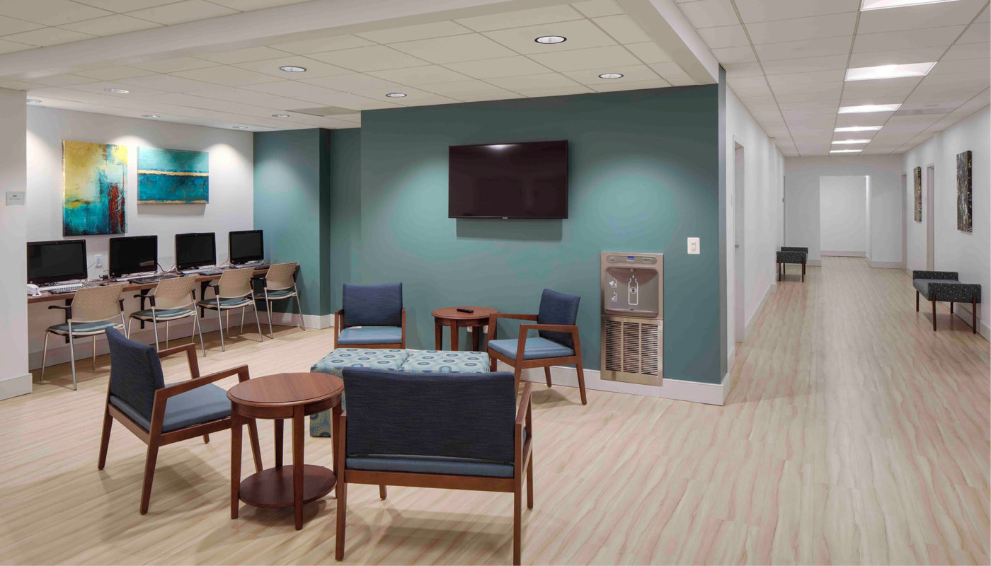 A well center waiting room with comfortable chairs and a television for wise individuals practicing healthy living.