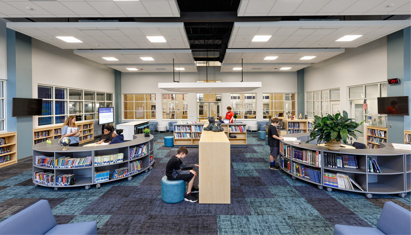 The interior of Liberty Middle School library with students sitting at tables.