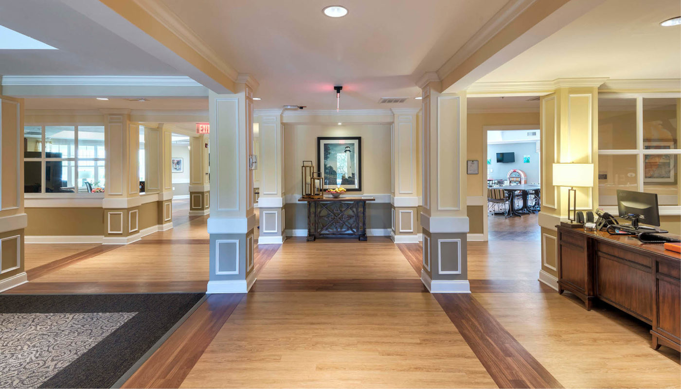 Candle Light Cove, a lobby adorned with hardwood floors and a captivating light fixture.