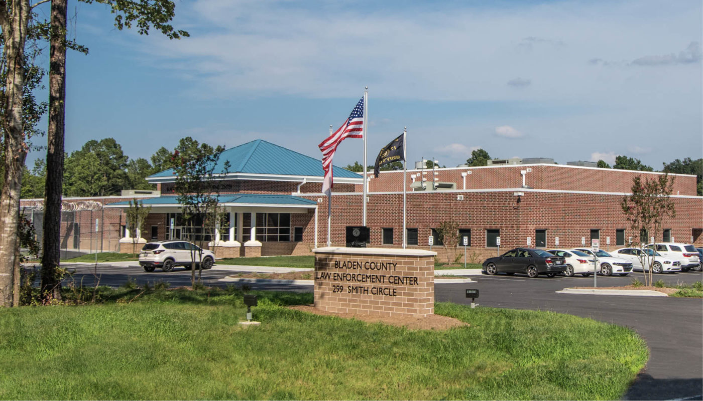 The front of a school building with an American flag, located in Bladen County.