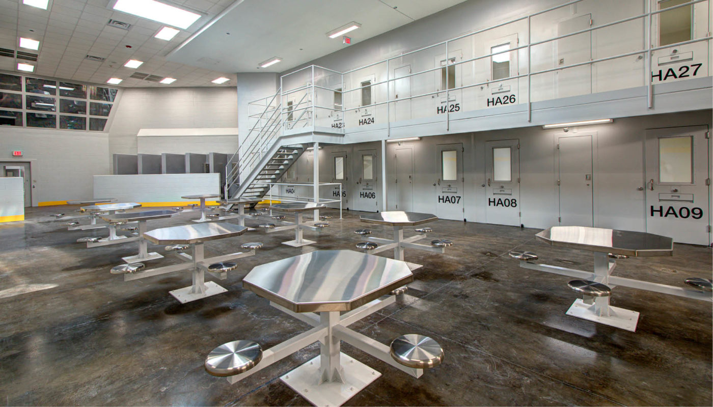 A room with tables and chairs at the Bladen County Detention Center.