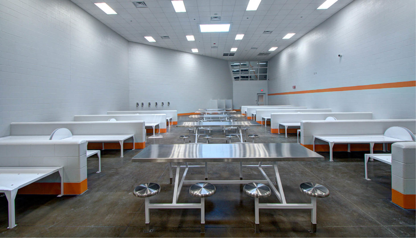 Bladen County Detention Center is equipped with a spacious room featuring tables and chairs.