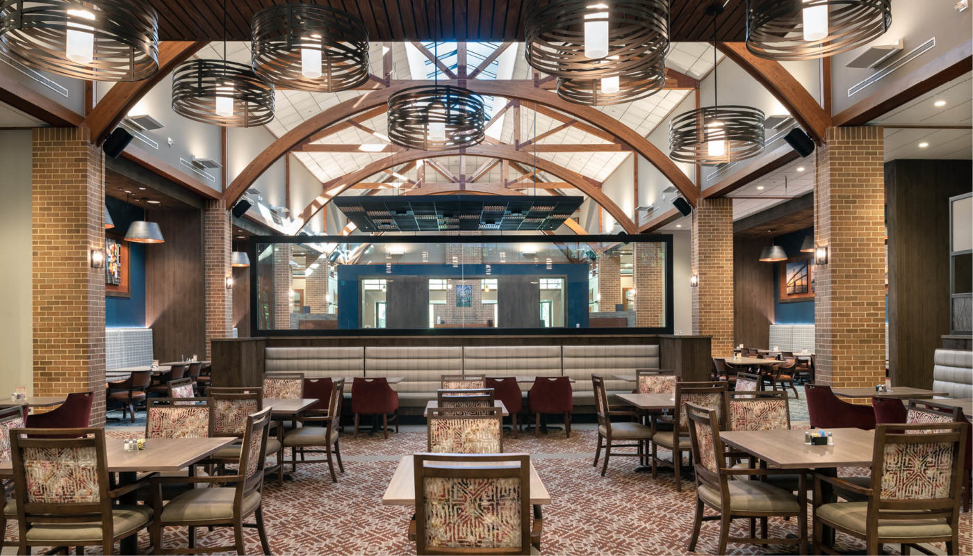 The rustic ambiance of Cross Creek restaurant in Charlestown is highlighted by its inviting interior with warm wooden ceilings and beautifully crafted tables.