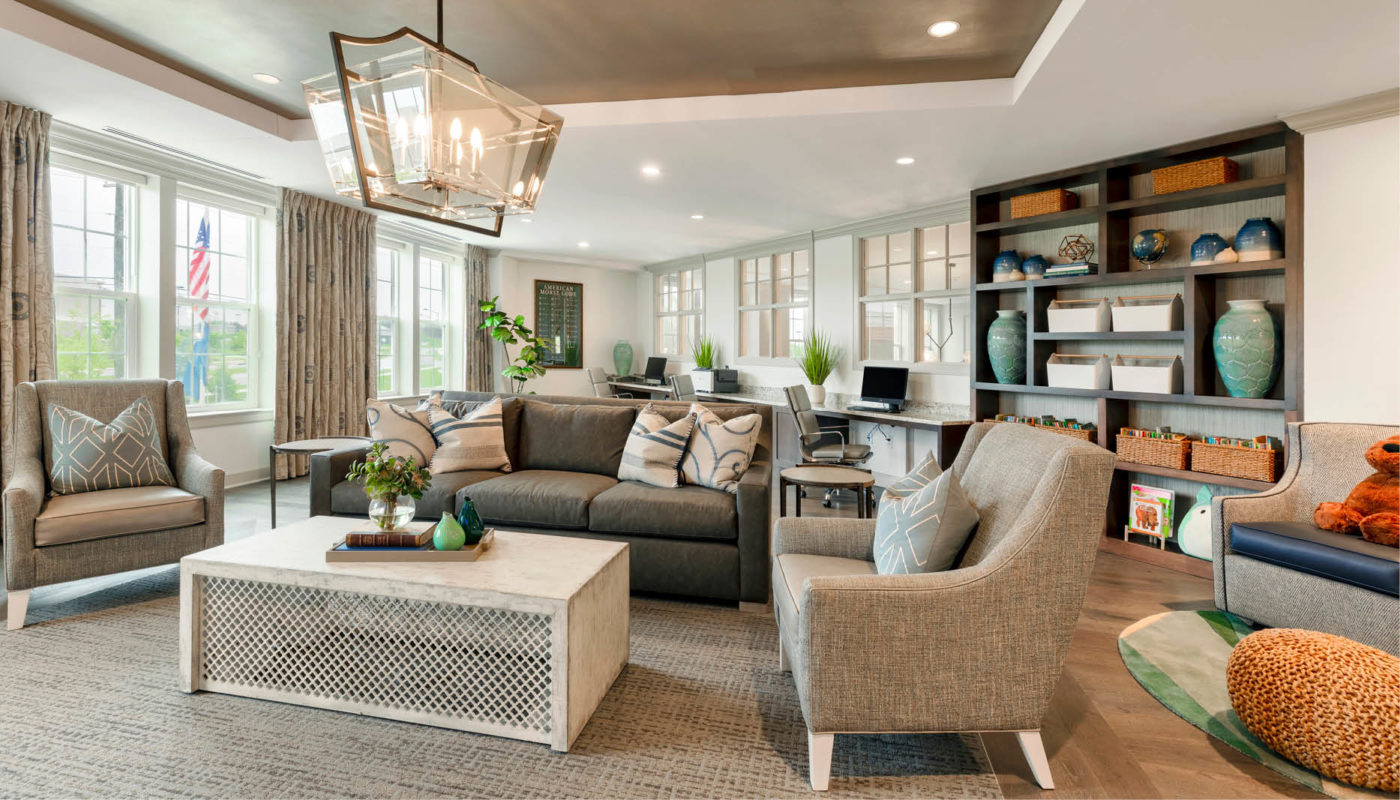 A living room at Arbor Terrace Waugh Chapel, featuring stylish couches and a sleek coffee table.