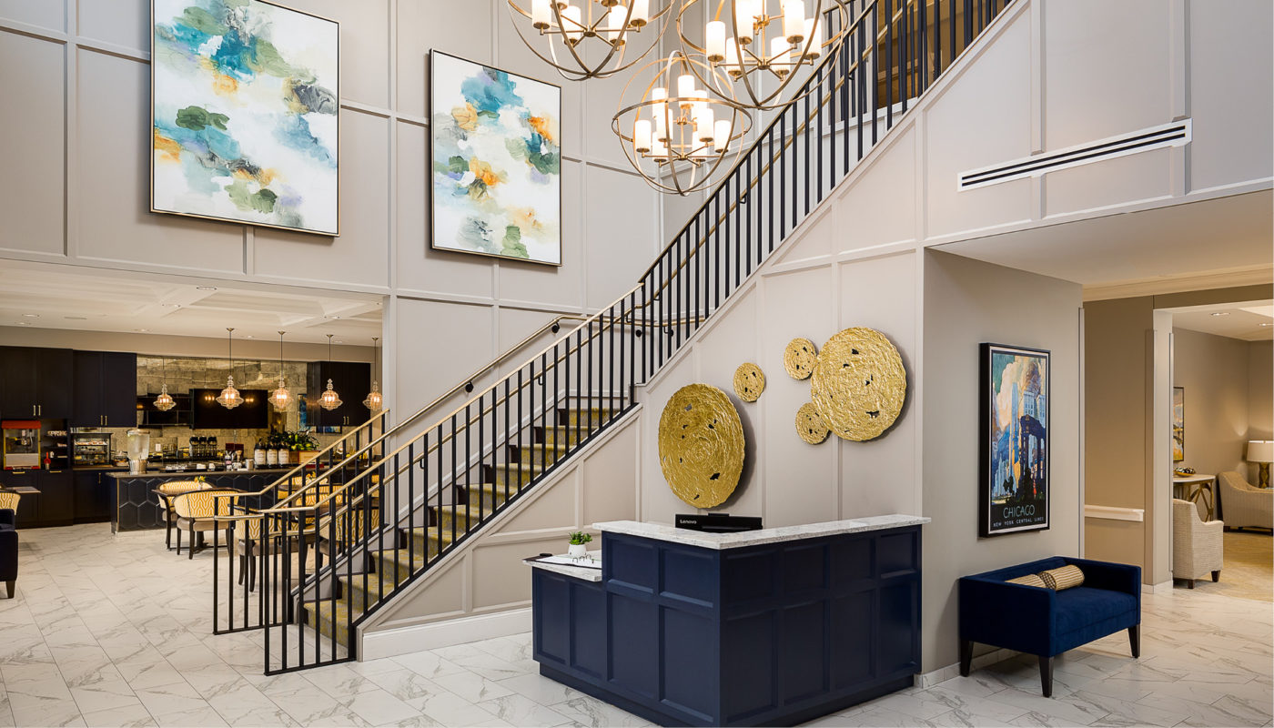 The Atria Glenview lobby showcases a luxurious atmosphere with its stunning gold staircase.