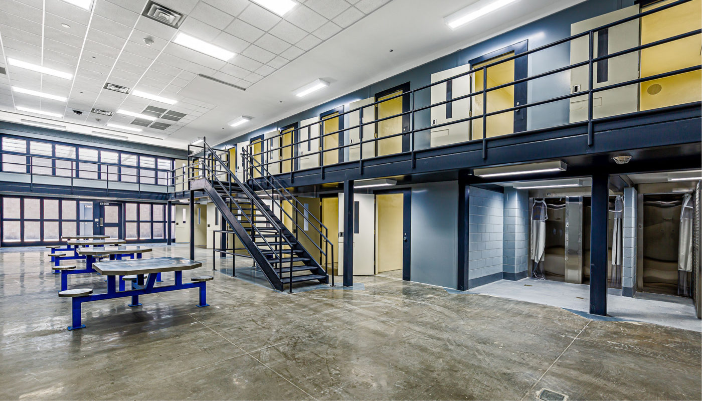 The inside of a Detention Center cell with stairs and tables located in Orangeburg County.