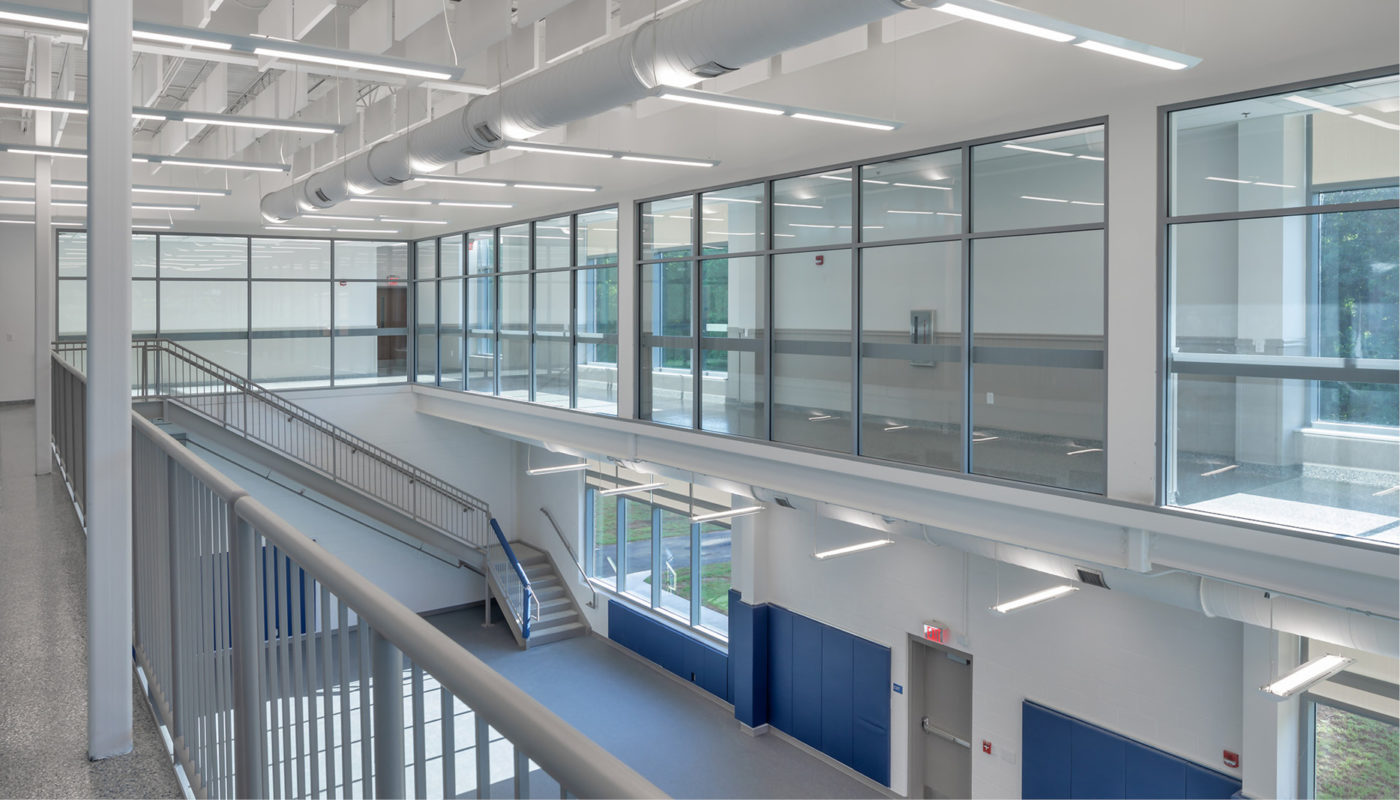 The interior of a school building with glass walls and stairs, modified to serve as a Law Enforcement Training Center in Raleigh.