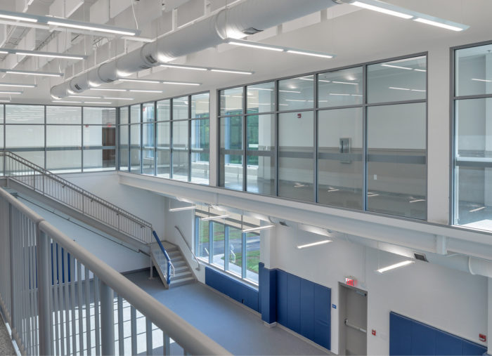 The interior of a school building with glass walls and stairs, modified to serve as a Law Enforcement Training Center in Raleigh.