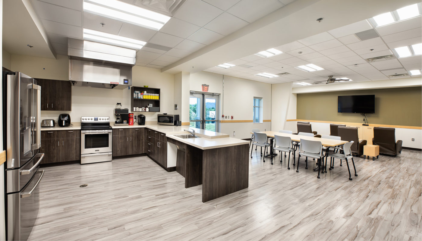 A kitchen and dining room in a hospital that resembles a fire station.