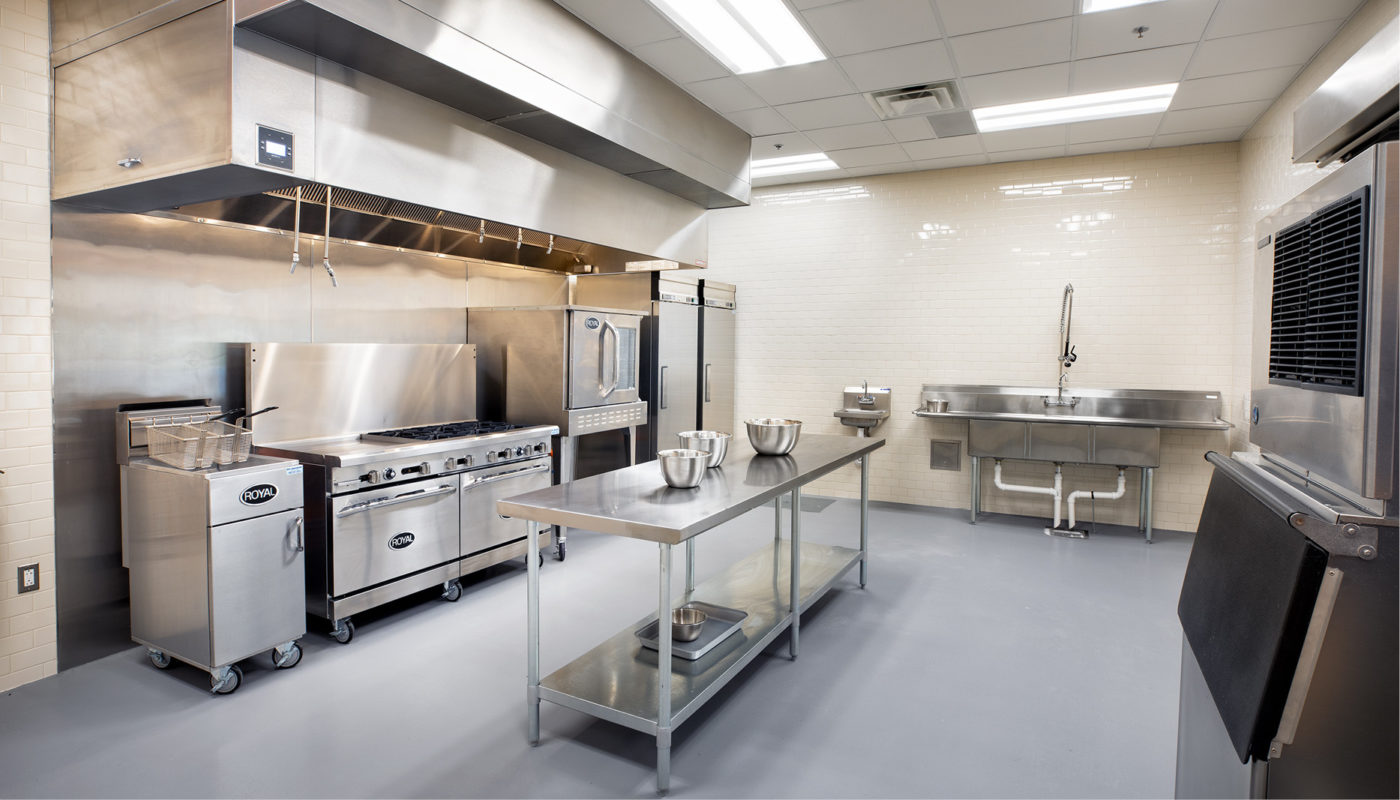 A large kitchen with stainless steel appliances designed for a fire station.