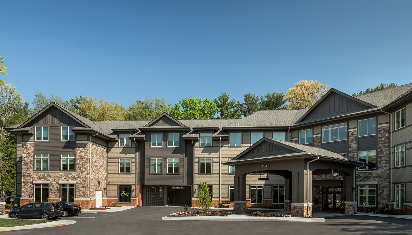 The exterior of a residential building in Reston with a parking lot.