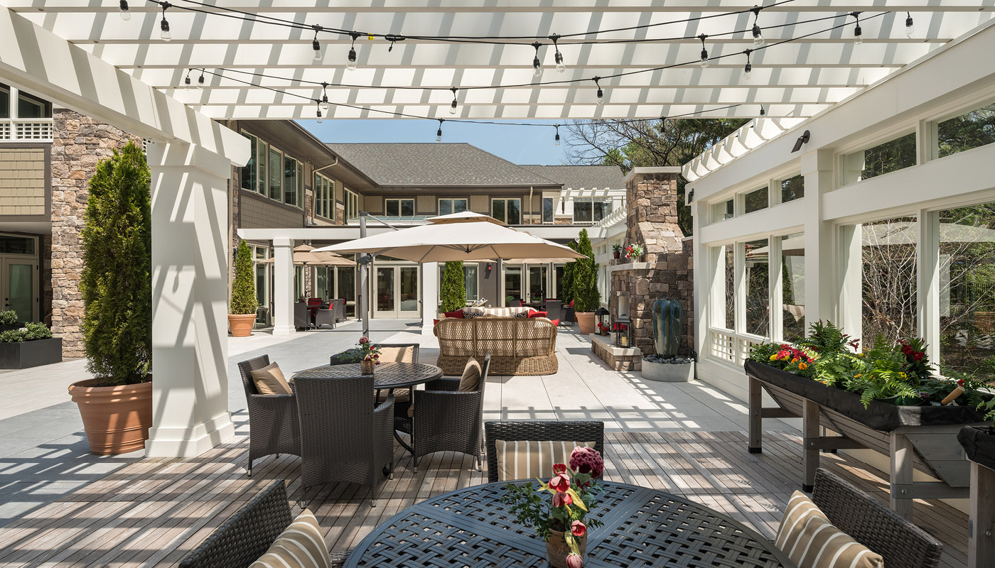 A Kensington patio with outdoor furniture and a pergola.