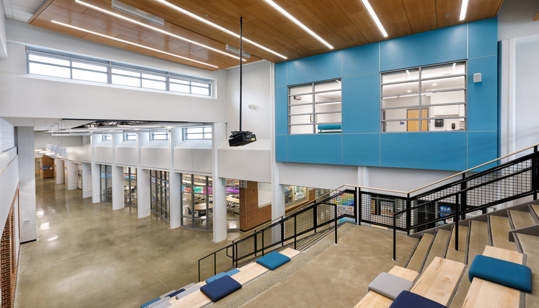 The interior of Holladay Elementary School with stairs and a blue wall.