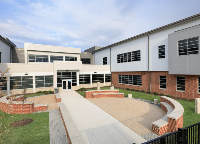 Holladay Elementary School, a brick building with a walkway, is located in Henrico County Public Schools.