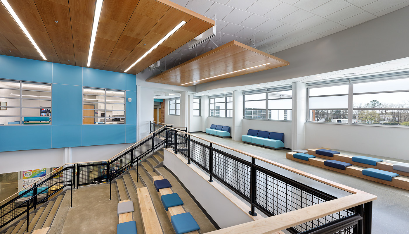 The interior of Holladay Elementary School, a Henrico County Public School building with blue walls and benches.