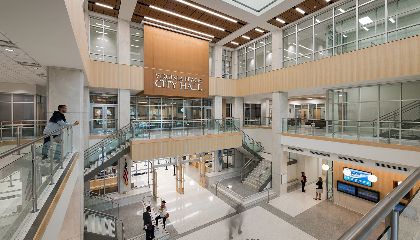 People gather throughout three-story lobby in Virginia Beach City Hall, a new municipal facility that blends traditional and contemporary architecture