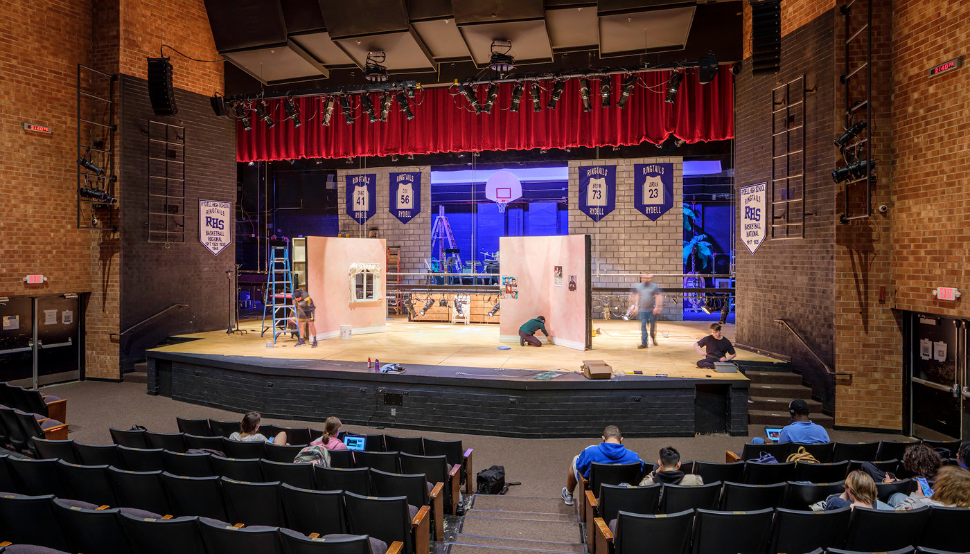 Students build set on stage in the auditorium of Chapel Hill High School, a renovated K-12 facility in North Carolina